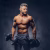 powerful-stylish-bodybuilder-with-tattoo-his-arm-doing-exercises-with-dumbbells-isolated-dark-background_613910-5202
